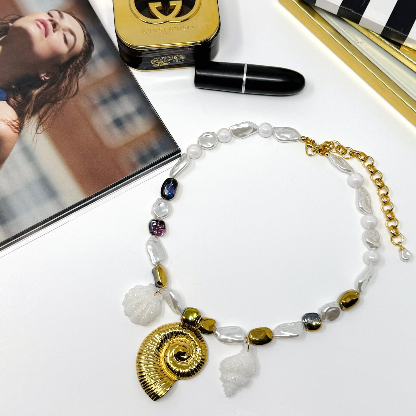 Handmade necklace of baroque pearls and Austrian crystals with gold-plated snail Pendant in stainless steel