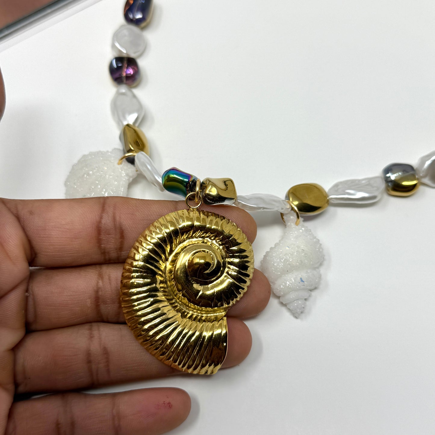 Handmade necklace of baroque pearls and Austrian crystals with gold-plated snail Pendant in stainless steel