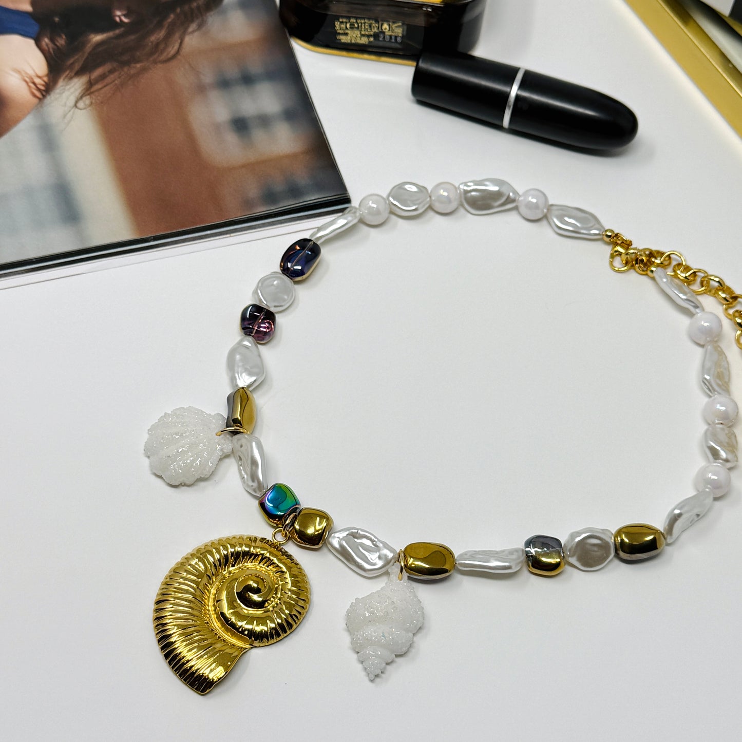 Handmade necklace of baroque pearls and Austrian crystals with gold-plated snail Pendant in stainless steel