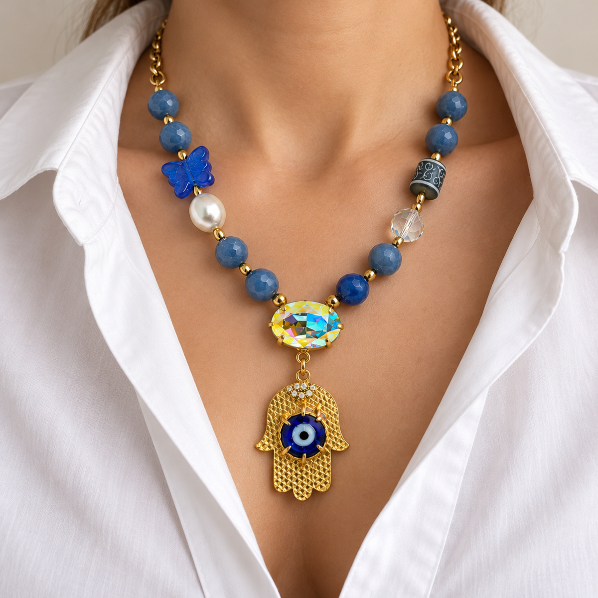 Blue aventurine hamsa necklace worn with a white blouse.