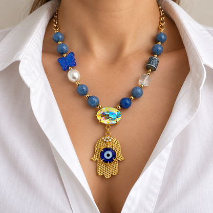 Blue aventurine hamsa necklace worn with a white blouse.