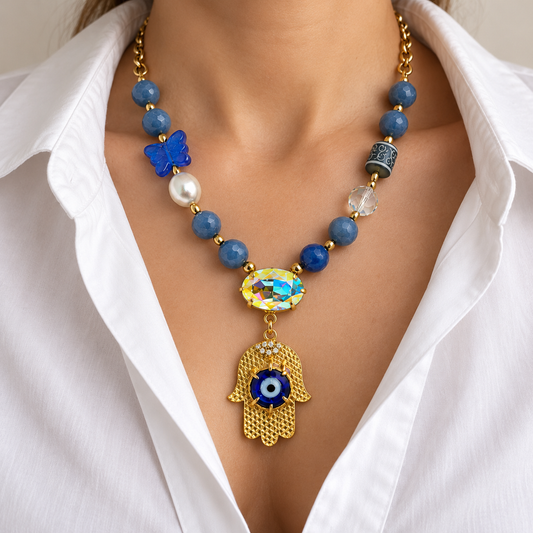 Blue aventurine hamsa necklace worn with a white blouse.