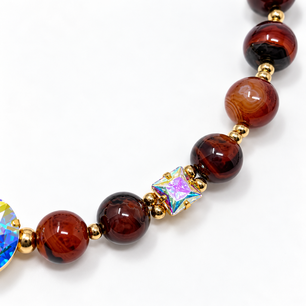 Close-up of agate beads and a square princess-cut Aurora Borealis crystal.