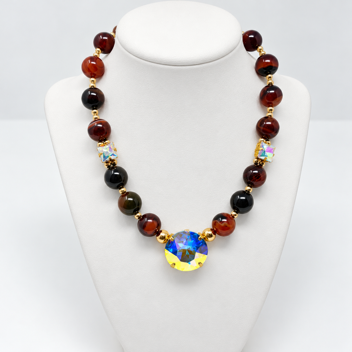 Natural agate Swarovski crystal necklace displayed on a white jewelry bust.