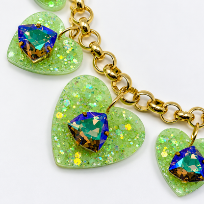 Close-up of sparkling green resin hearts and Scarabaeus Green trilliant Swarovski crystals.