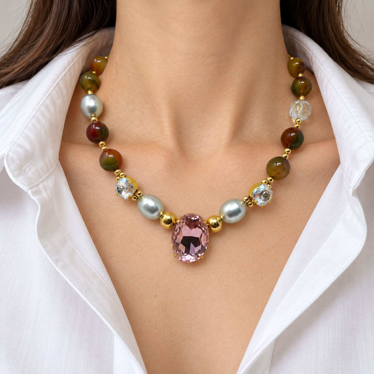 Mixed agate and pearl Swarovski crystal necklace worn with a white blouse.