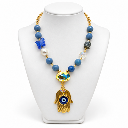 Blue aventurine hamsa necklace displayed on a white jewelry bust.
