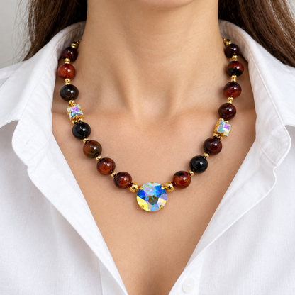 Agate and Aurora Borealis crystal necklace worn with a white blouse.