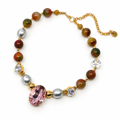 Agate and pearl necklace with a pink oval Swarovski crystal and two clear crystal accents on a white background.