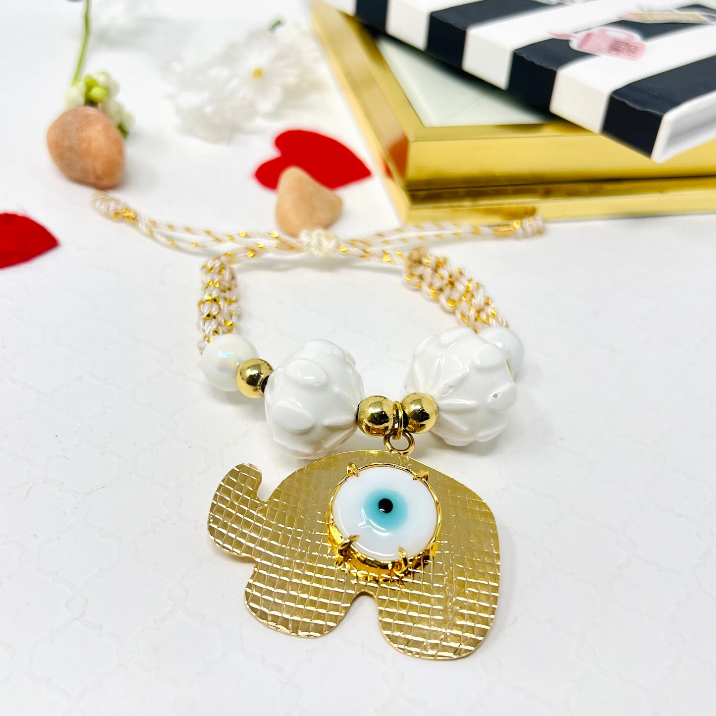 Gold plated elephant charm bracelet with ceramic and gold plated beads woven in macrame