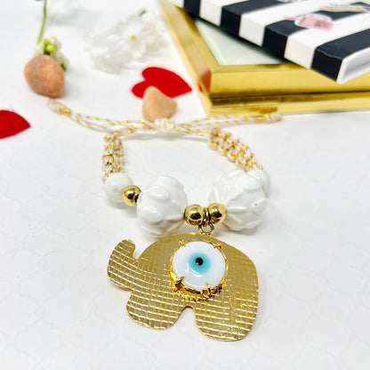 Gold plated elephant charm bracelet with ceramic and gold plated beads woven in macrame