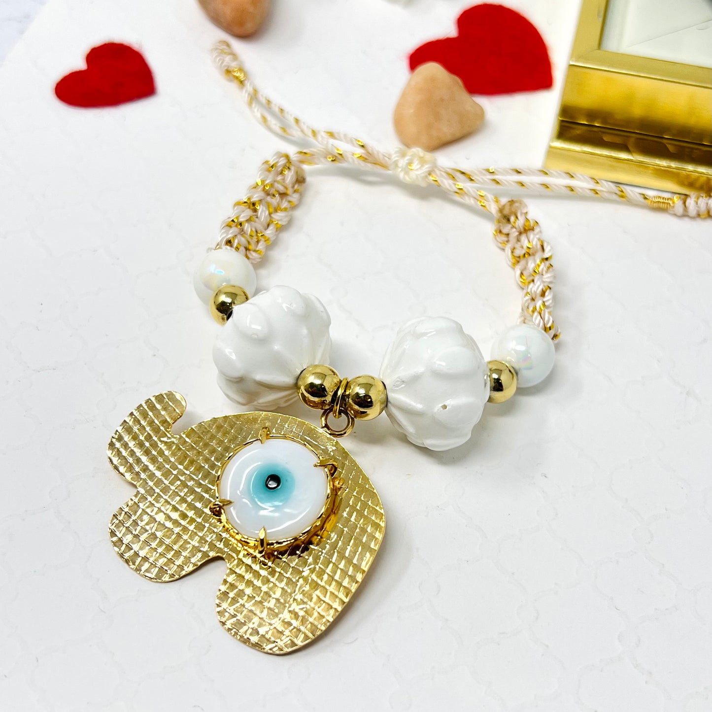 Gold plated elephant charm bracelet with ceramic and gold plated beads woven in macrame