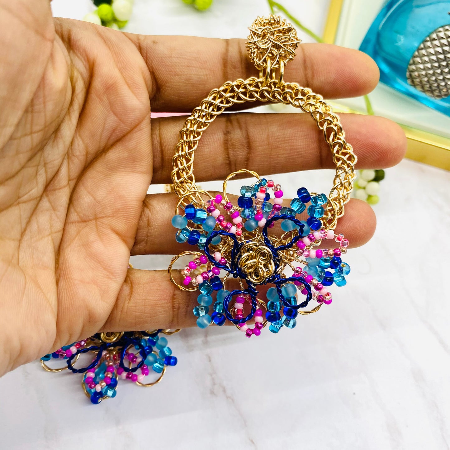 Gold wire embroidered circle with flower earring