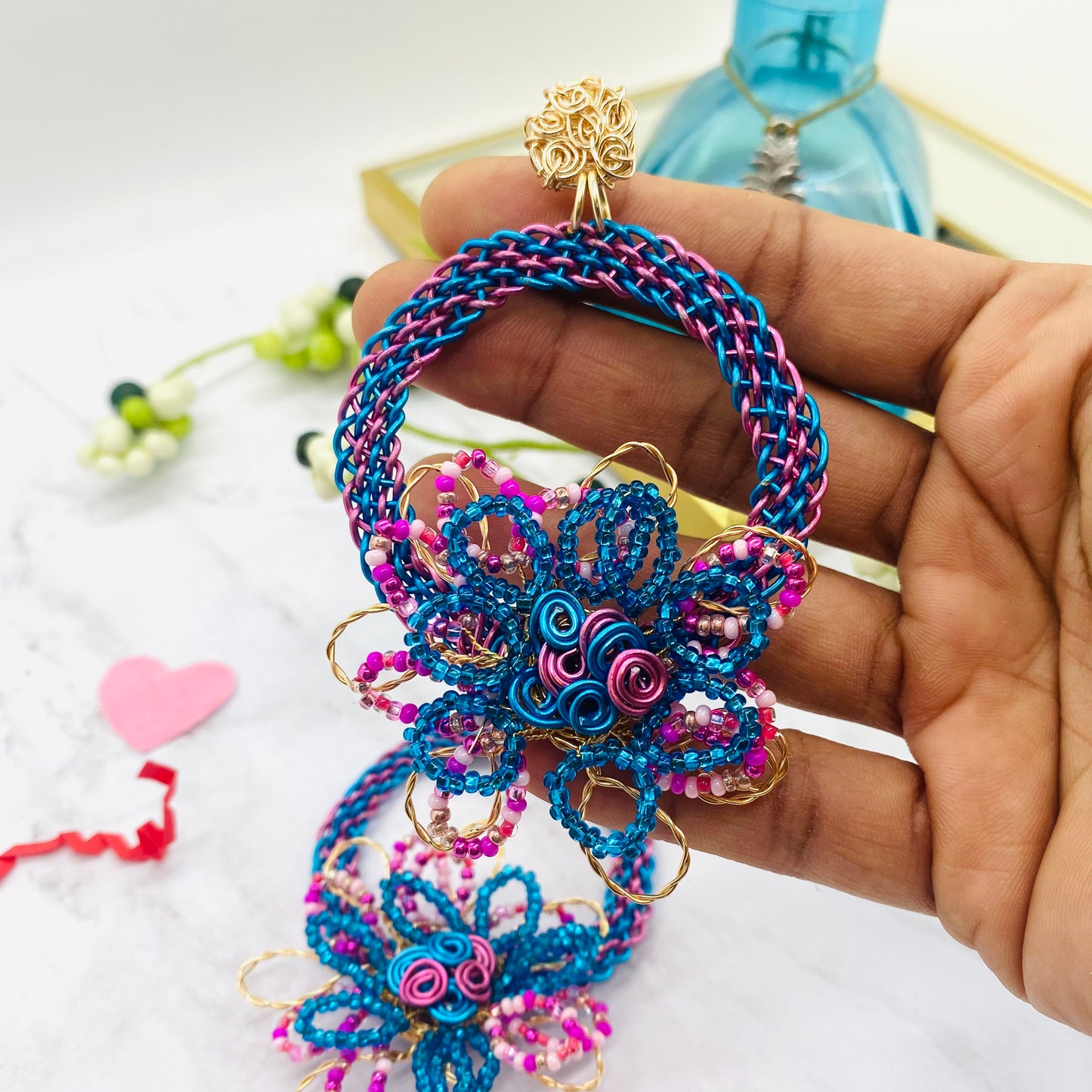 Gold wire embroidered circle with flower earring