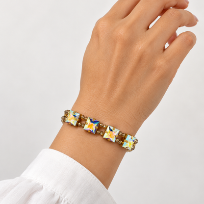Adjustable Czech bead bracelet with four square Aurora Borealis Swarovski crystals, shown on the wrist.