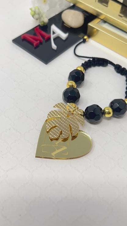 Black bracelet woven in adjustable macrame with gold laminated beads