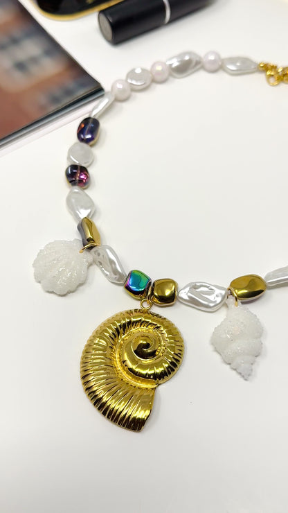 Handmade necklace of baroque pearls and Austrian crystals with gold-plated snail Pendant in stainless steel
